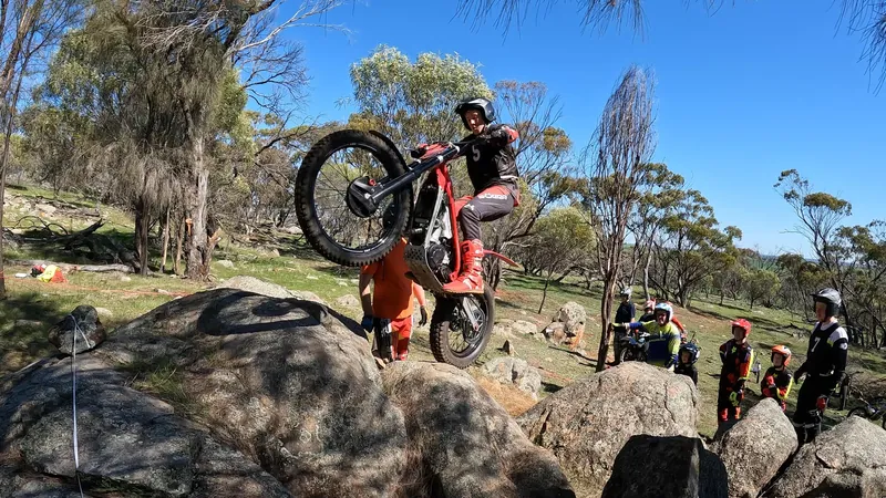Pathfinders rider lifting the front wheel onto a rock obstacle
