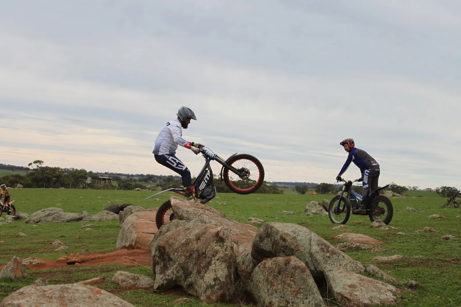 Pathfinders riders practising precise bike control on a rock section