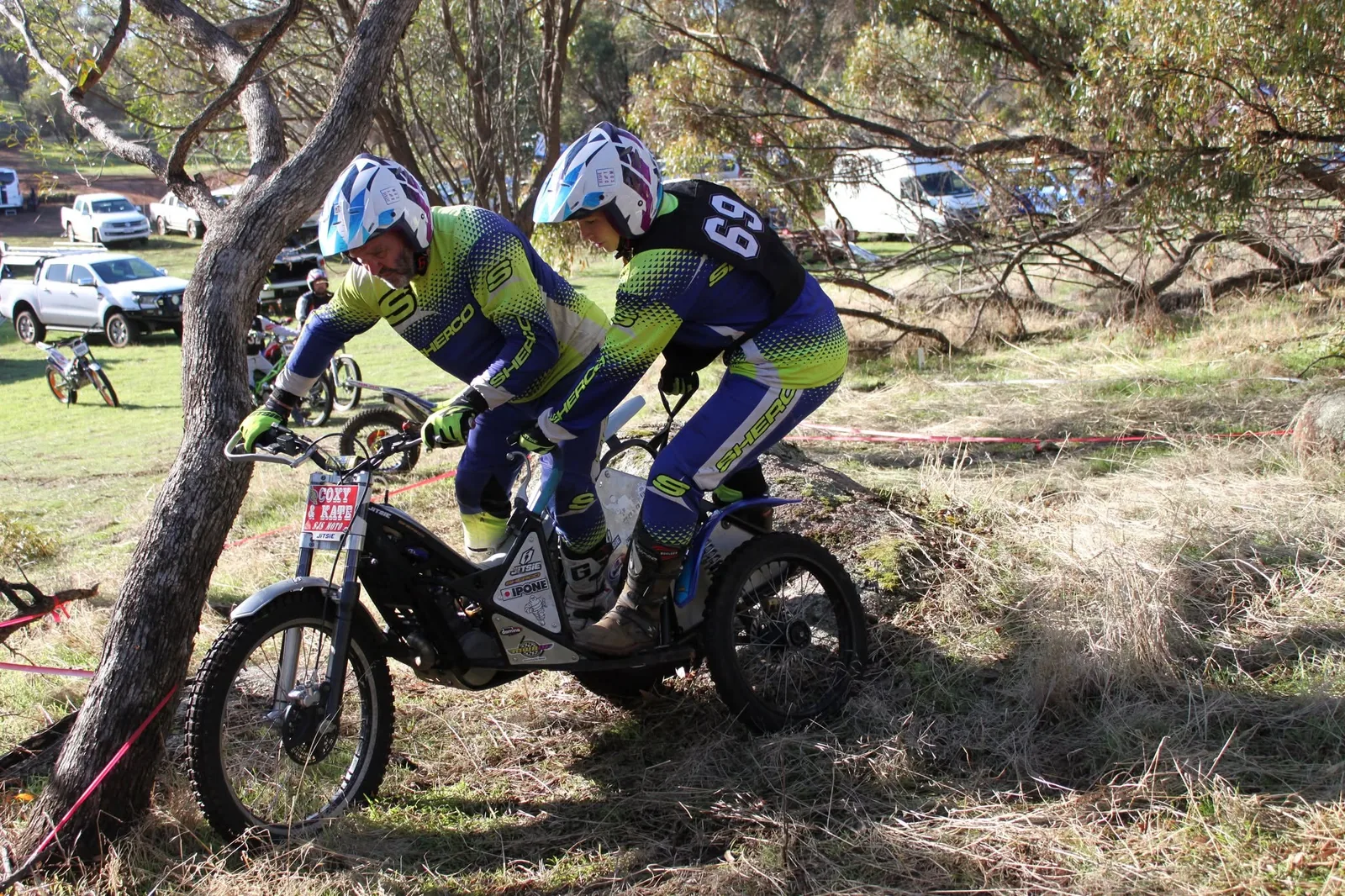 Sidecar trials team riding through a natural section