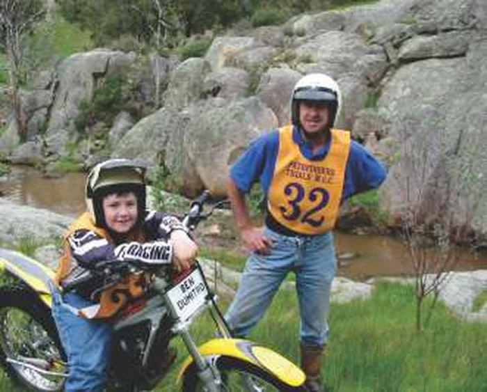 Two Pathfinders members with a trials motorcycle at Immediate Metals in 2003