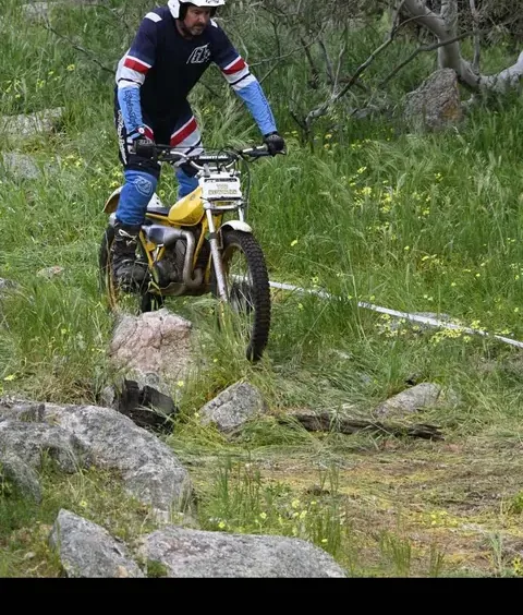 Classic trials motorcycle being ridden through a rocky WA section