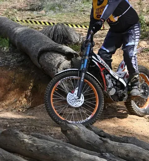 Pathfinders rider negotiating a log section