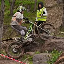 Trials rider climbing a natural rock section at the 2025 WA State Championships
