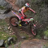 Trials competitor riding through technical natural terrain at the 2025 WA State Championships