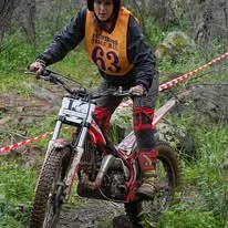 Trials rider balancing through a championship section in Western Australia