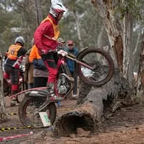 Trials competitor riding through technical natural terrain at the 2025 WA State Championships