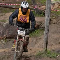 Trials rider balancing through a championship section in Western Australia