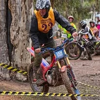 Trials rider climbing a natural rock section at the 2025 WA State Championships