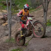 Trials rider balancing through a championship section in Western Australia