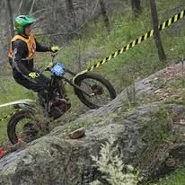 Trials rider climbing a natural rock section at the 2025 WA State Championships