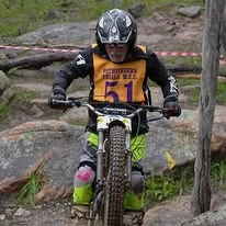Trials rider climbing a natural rock section at the 2025 WA State Championships
