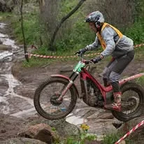 Trials competitor riding through technical natural terrain at the 2025 WA State Championships