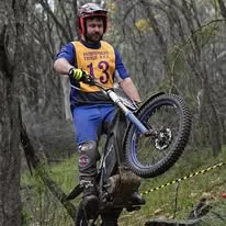 Trials rider climbing a natural rock section at the 2025 WA State Championships