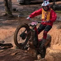 Trials rider balancing through a championship section in Western Australia